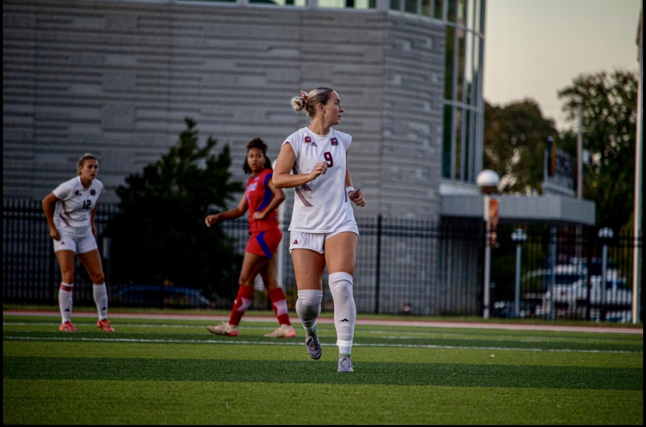 Macee McKenna in a Missouri State white #9 jersey jogging into position during a match