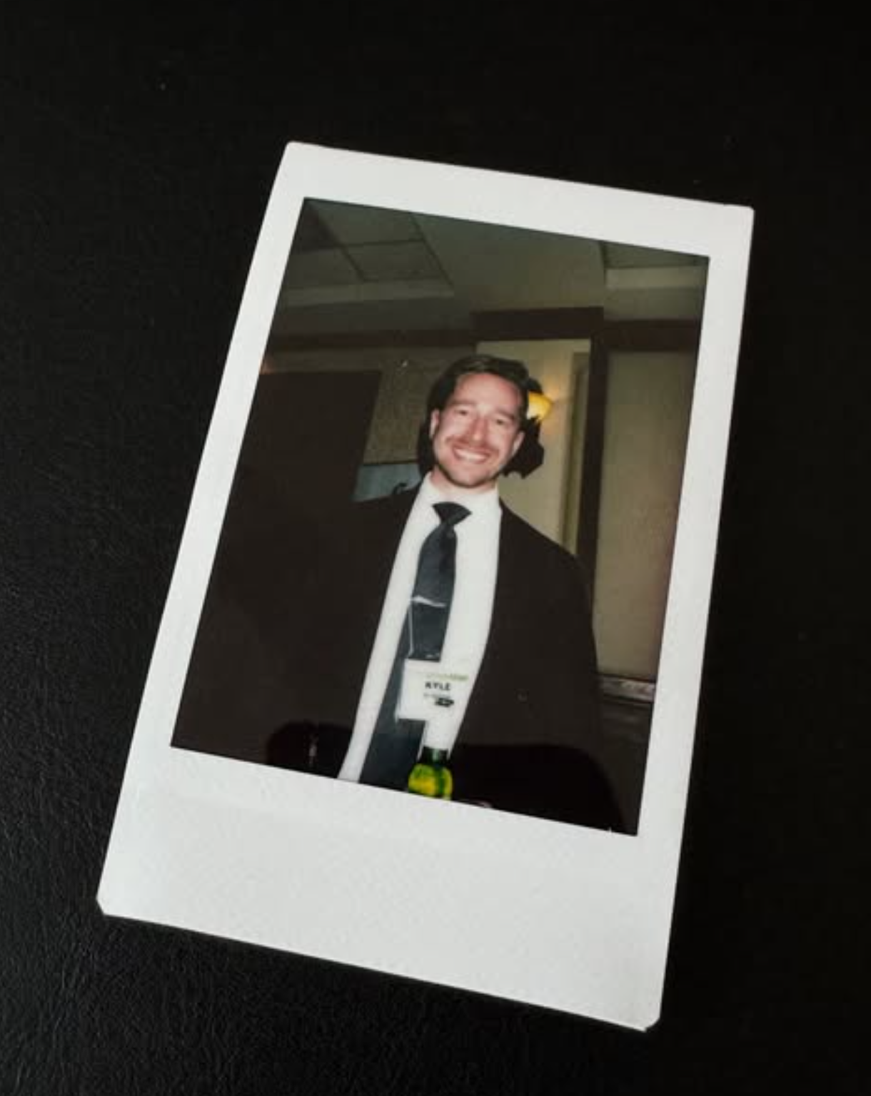 Polaroid of Kyle in a suit and tie