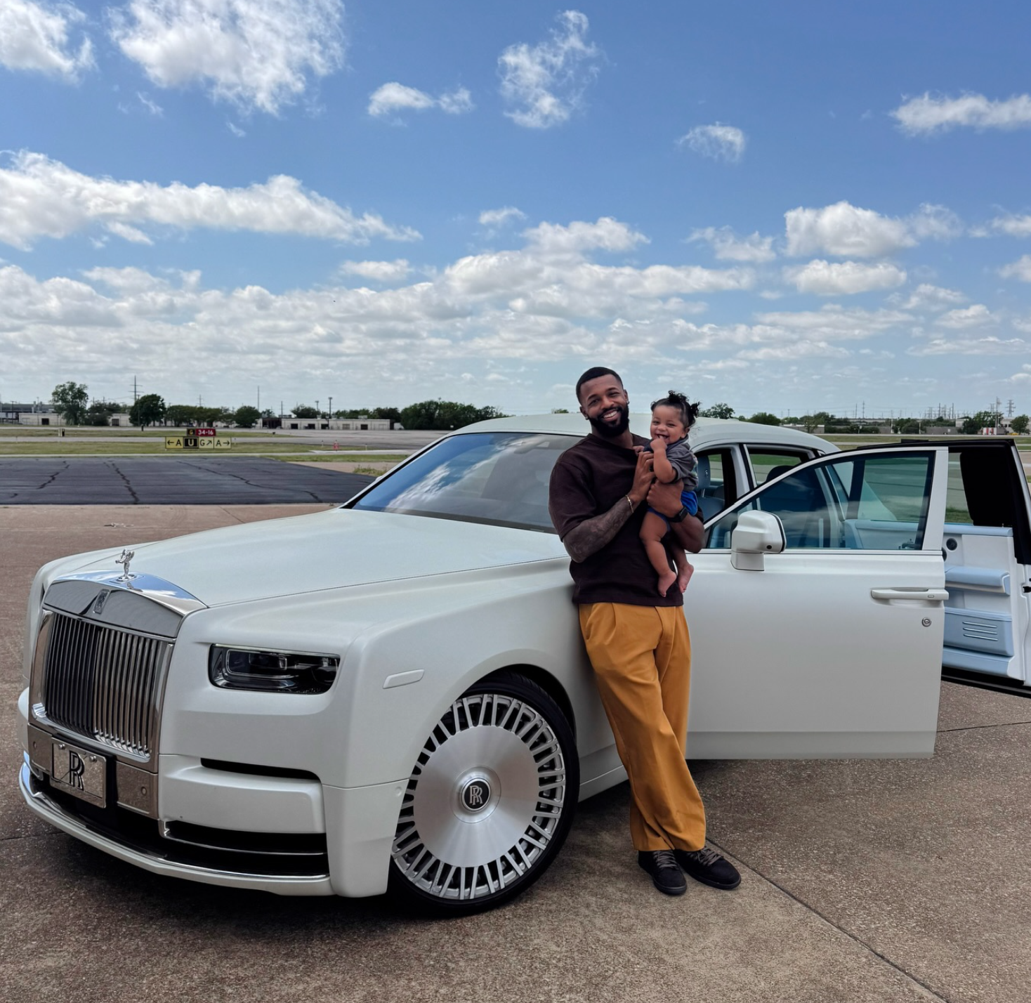 Josh Butler with family by a Rolls-Royce