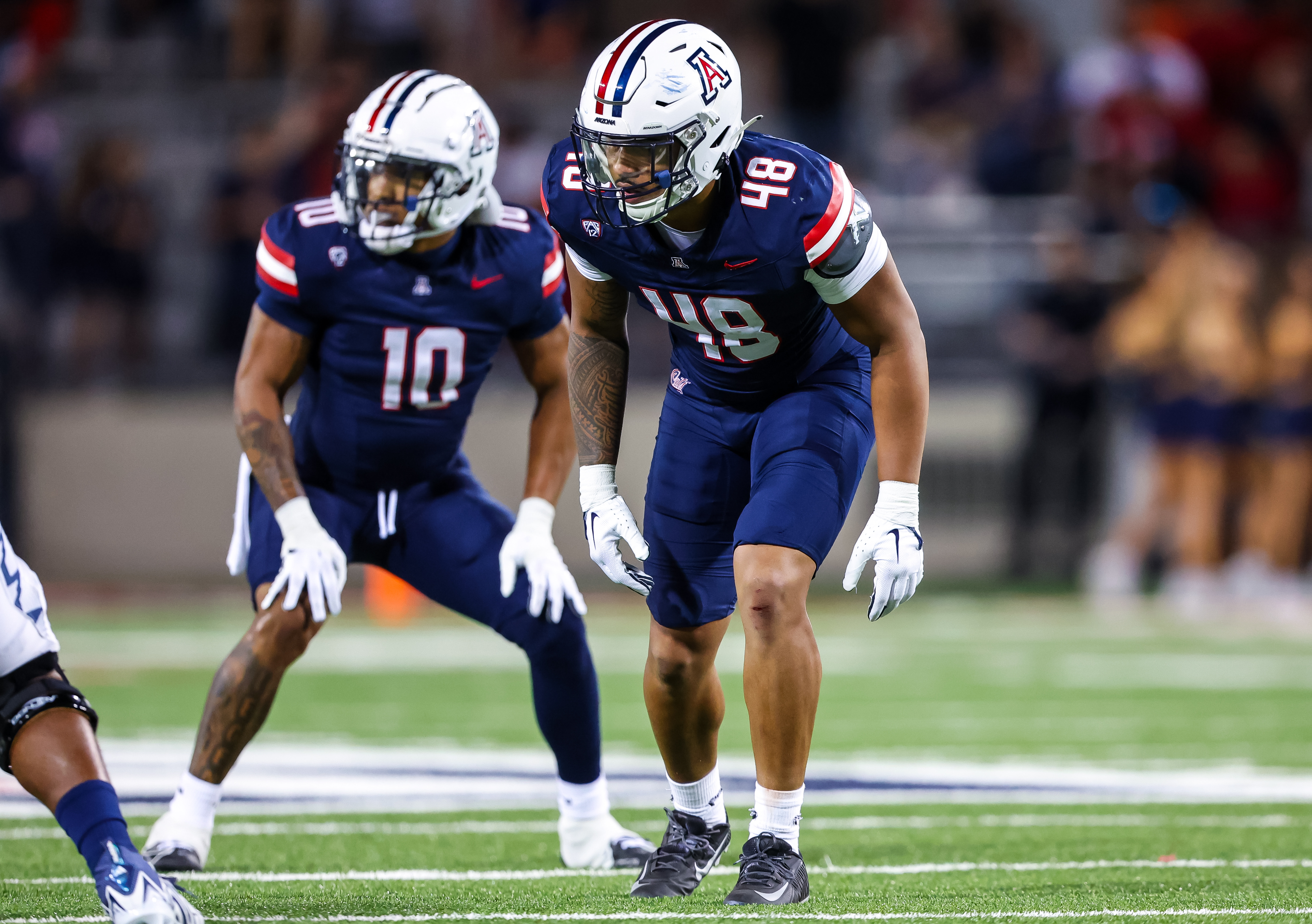 Orin Patu set in stance at the line of scrimmage in his Arizona uniform