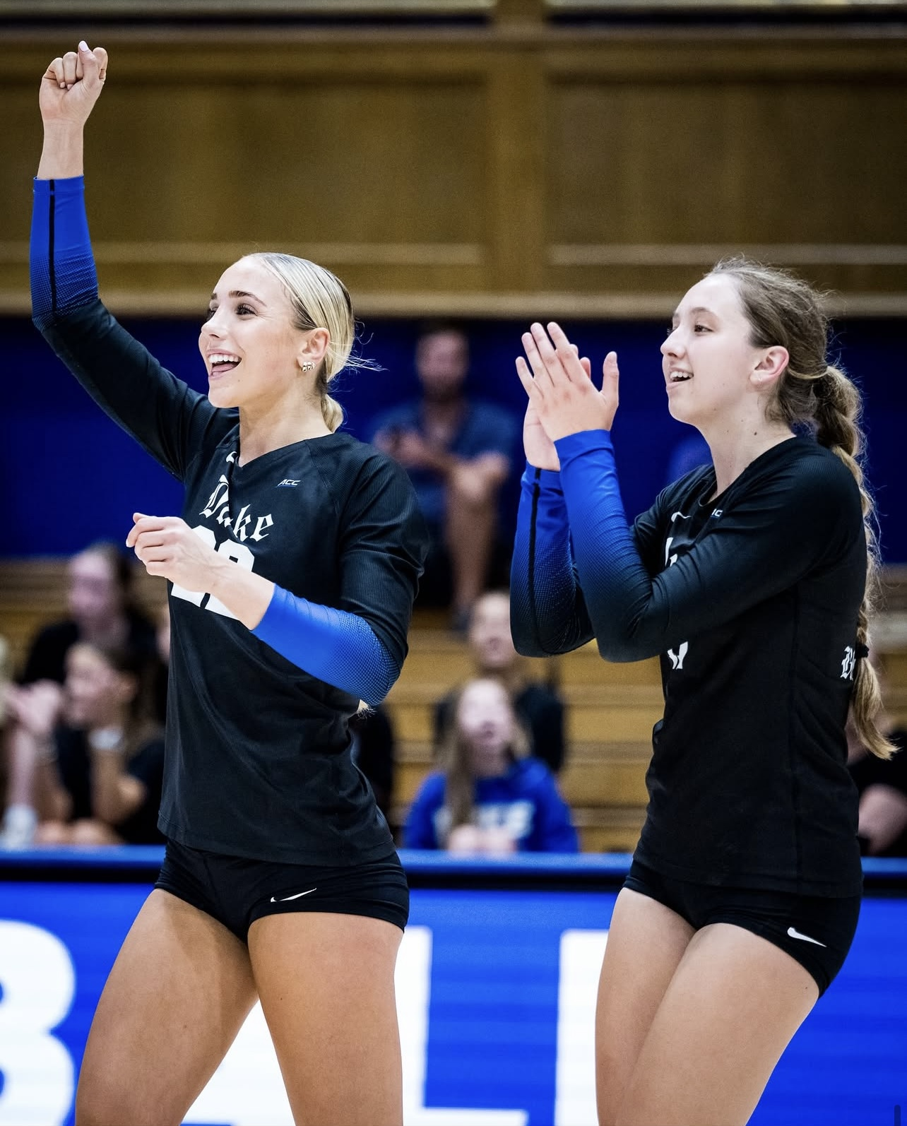 Charlotte Glass celebrating in a black Duke volleyball jersey