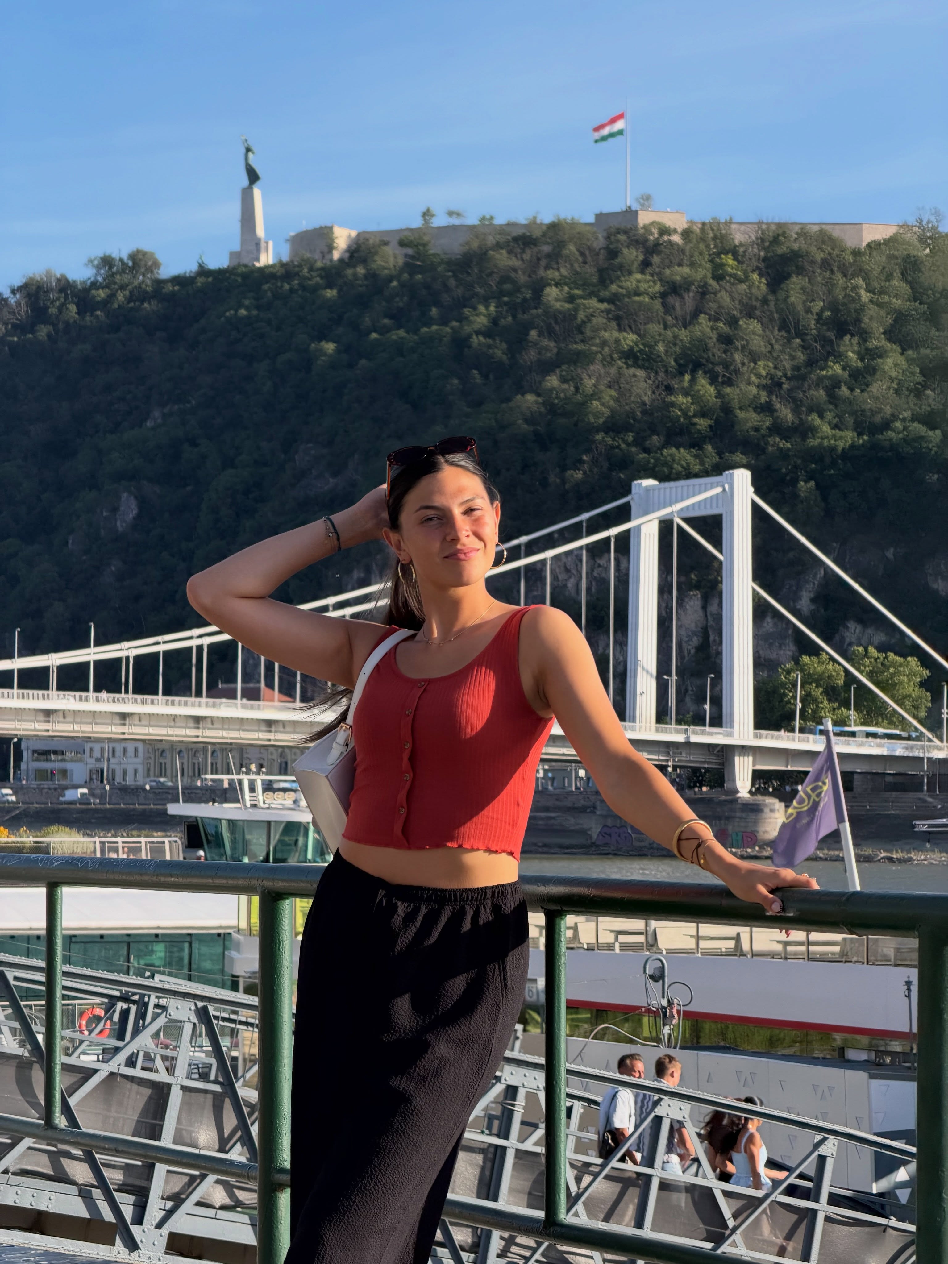 Céline Dept smiling in front of the Danube and Elisabeth Bridge in Budapest