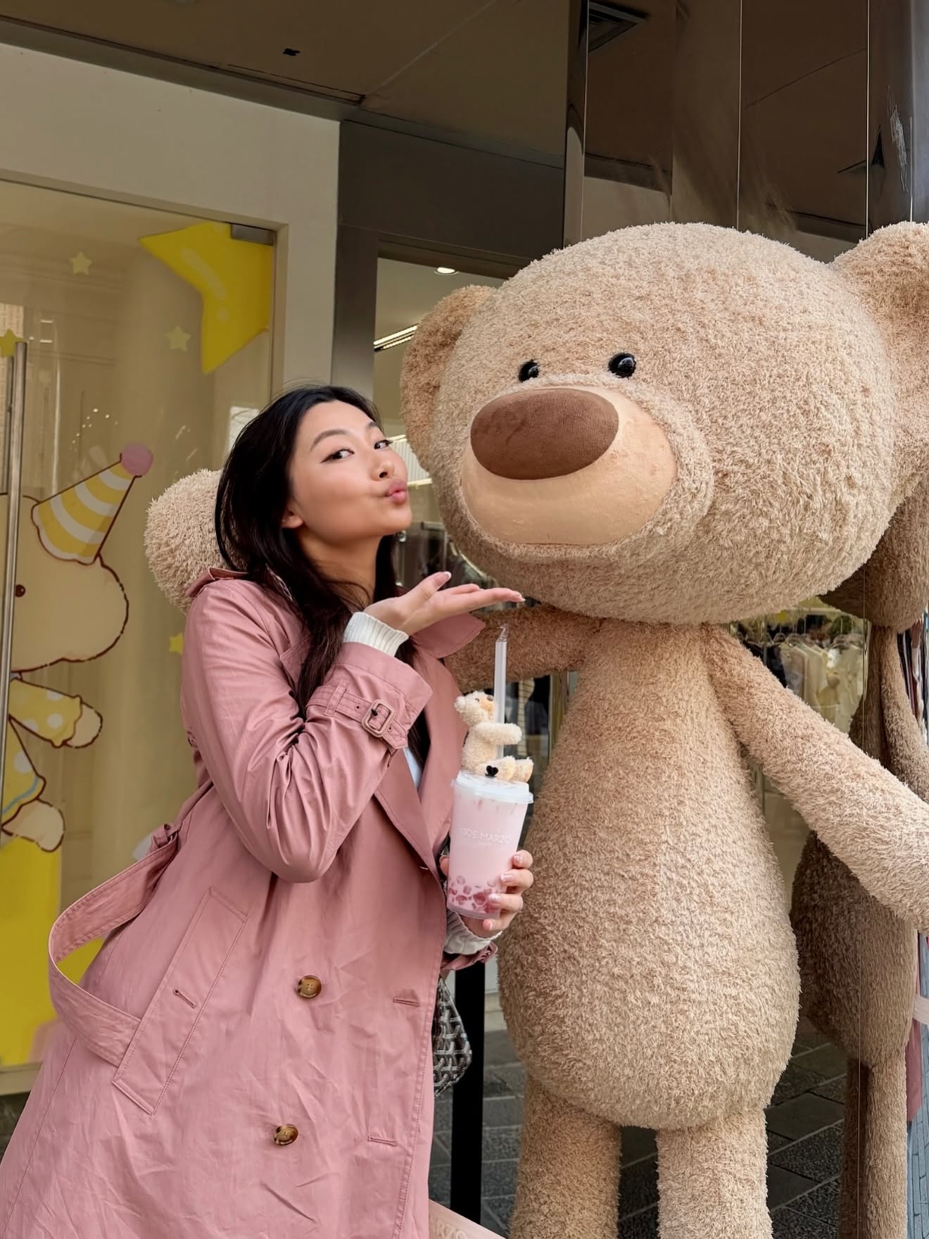 Mia Yilin posing with a giant teddy bear