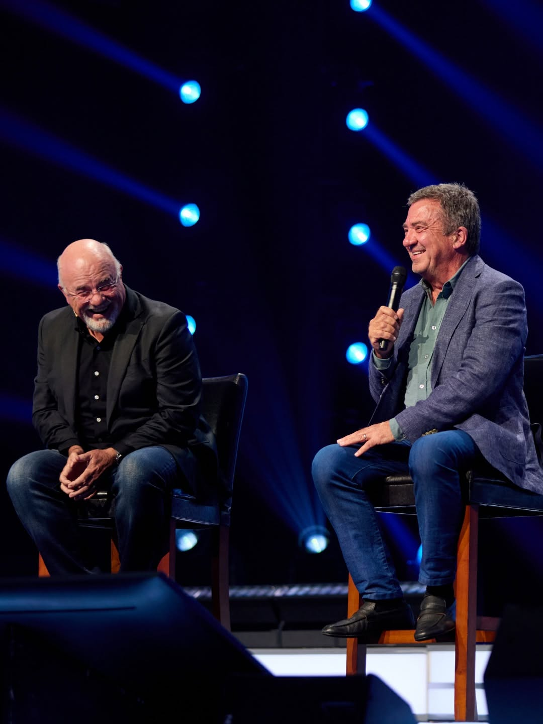 Dave Ramsey on stage in conversation under stage lights