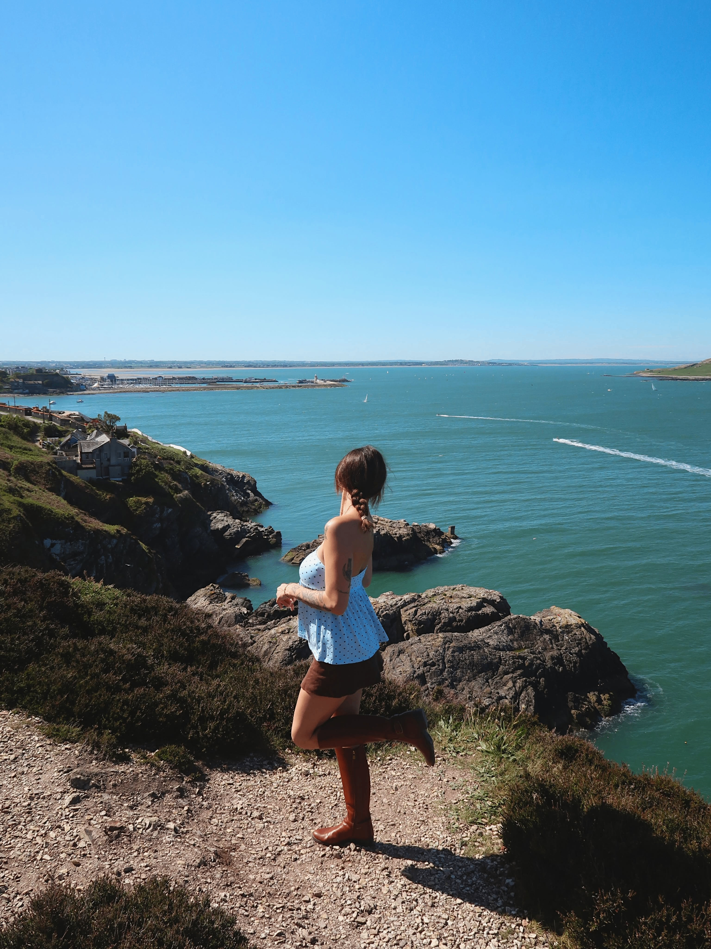 Bri Maloney on a cliff overlooking the sea in Howth, Ireland