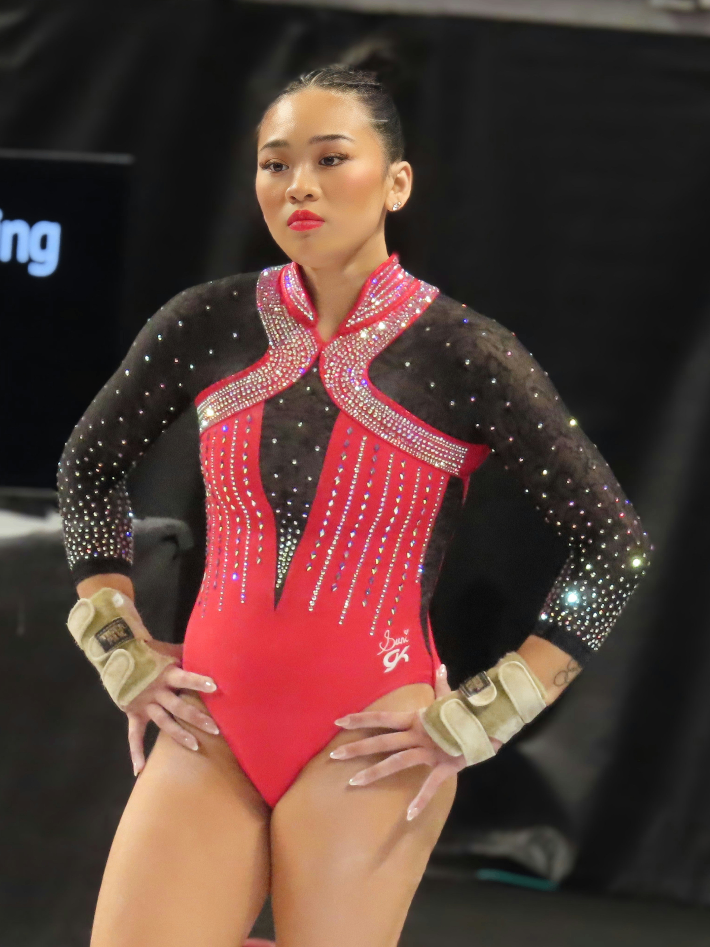 Sunisa Lee in a red and black competition leotard