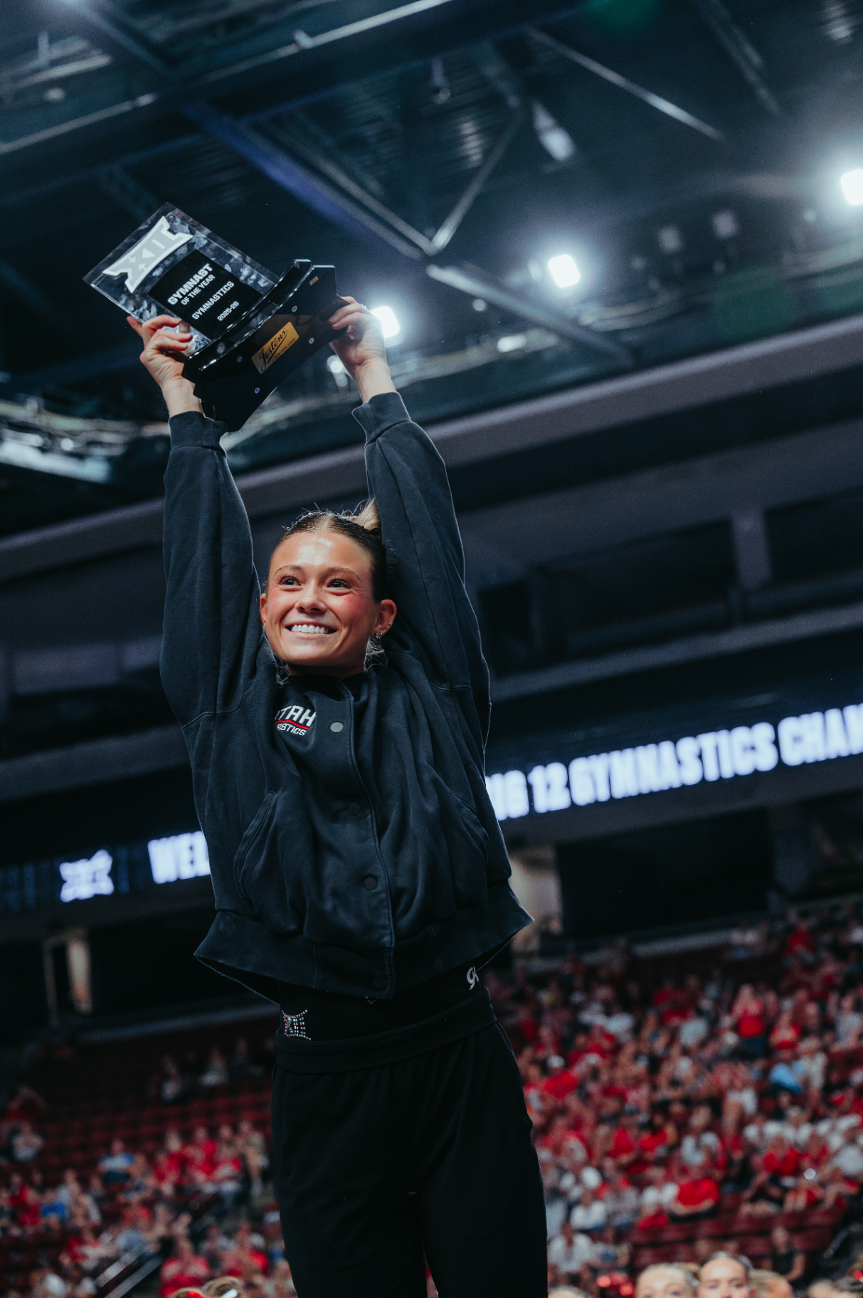 Avery Neff holding up a gymnastics award