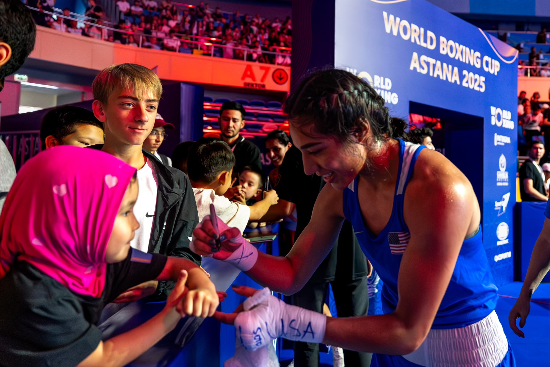 Yoseline Perez signing autographs for young fans at the World Boxing Cup in Astana