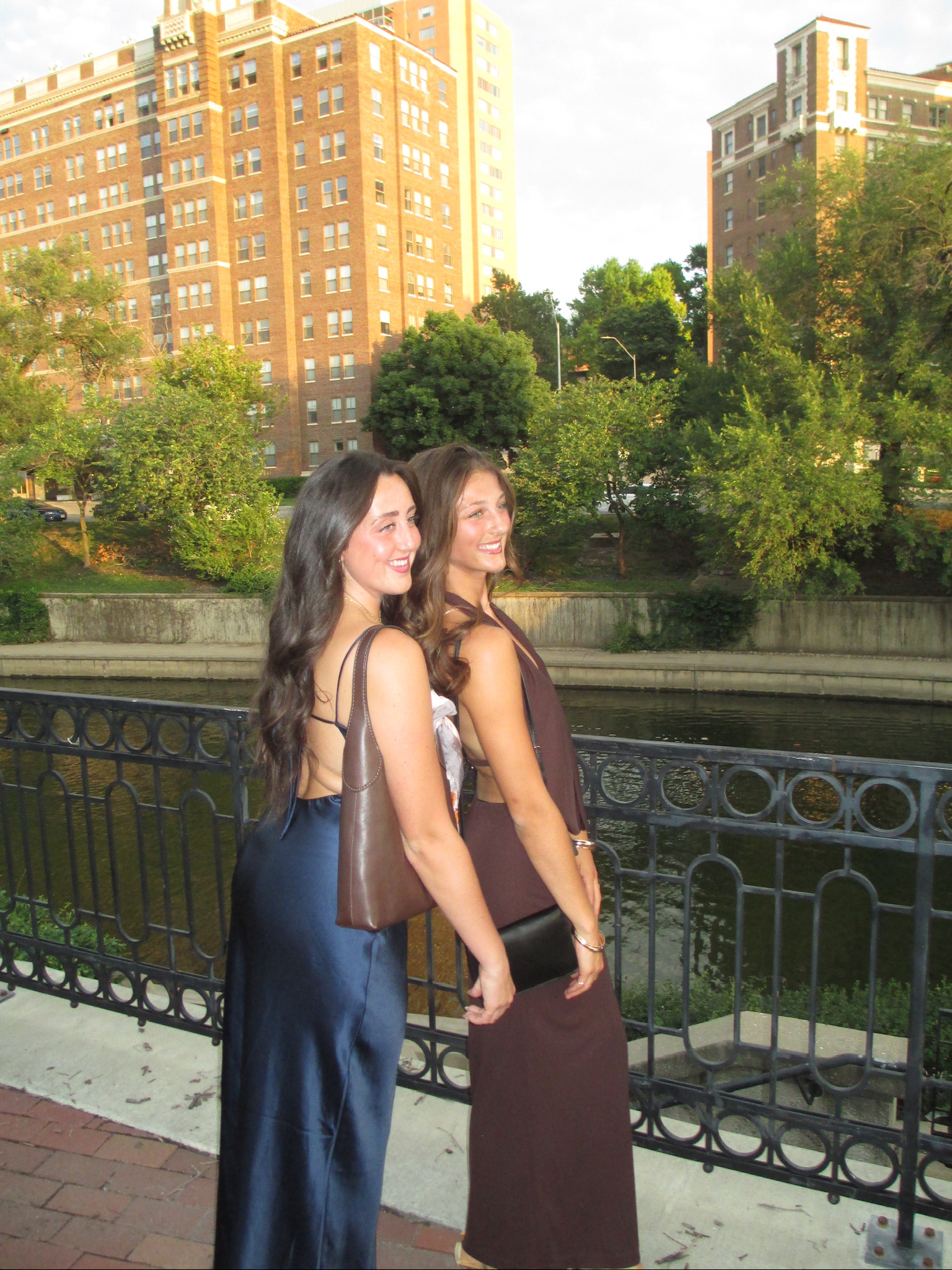Logan Bell with a friend by a river at sunset