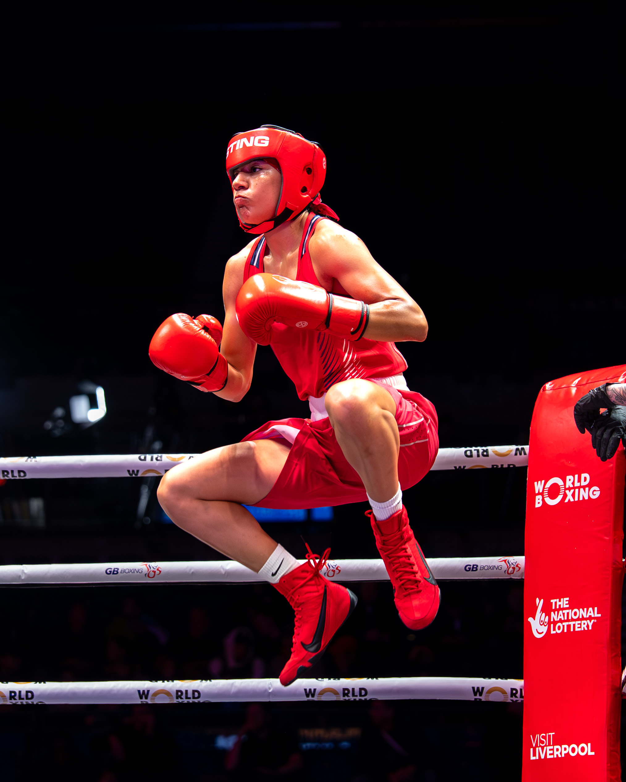 Yoseline Perez emotional in the ring as her hand is raised in victory wearing the USA singlet
