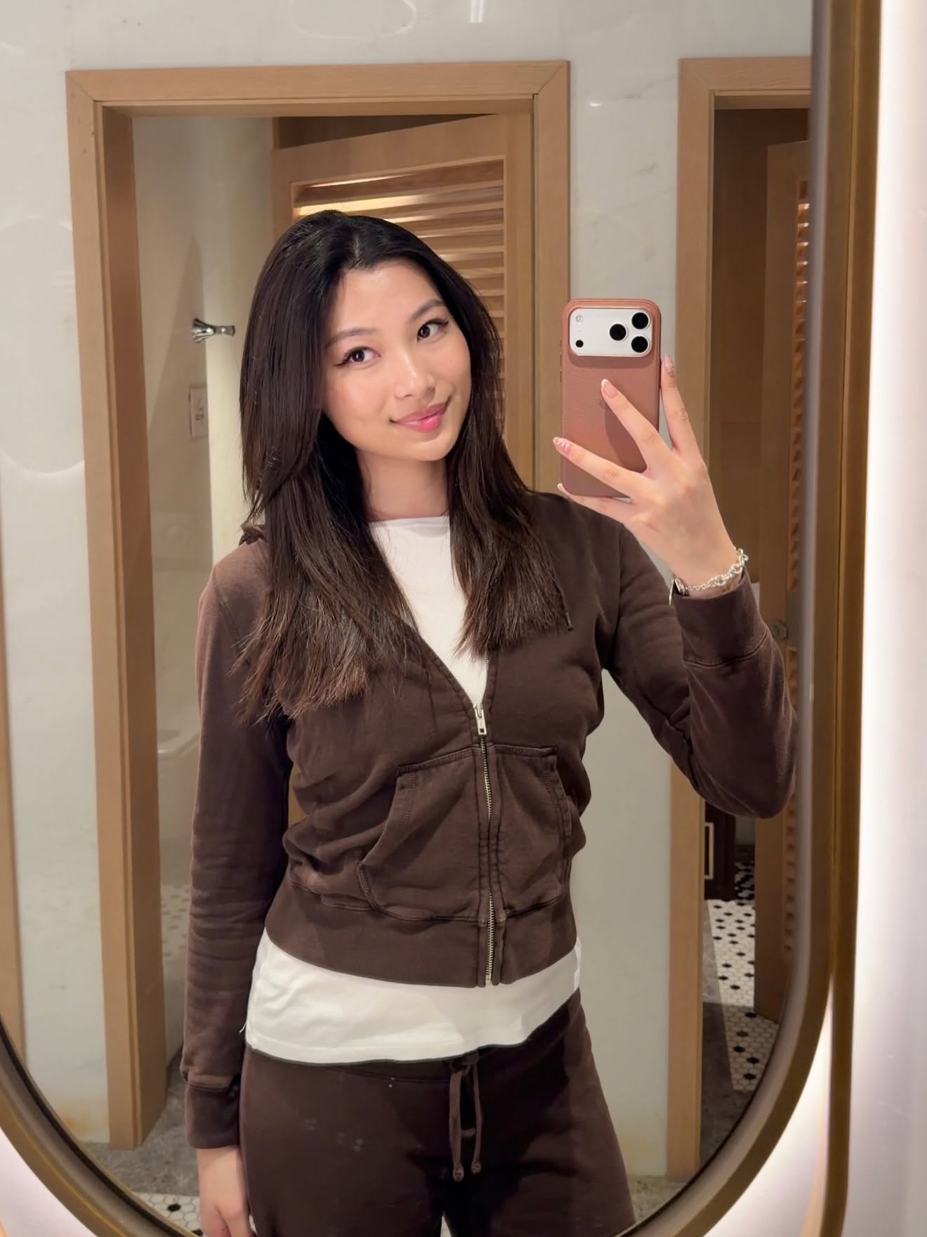 Mia Yilin mirror selfie in a brown set