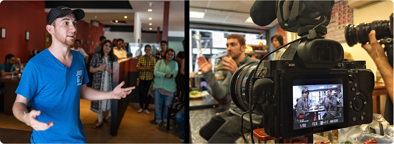 Drew Binsky speaking to a crowd, behind the scenes camera capturing the moment