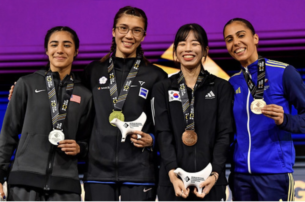 Yoseline Perez holding her silver medal alongside fellow medalists at the World Championships