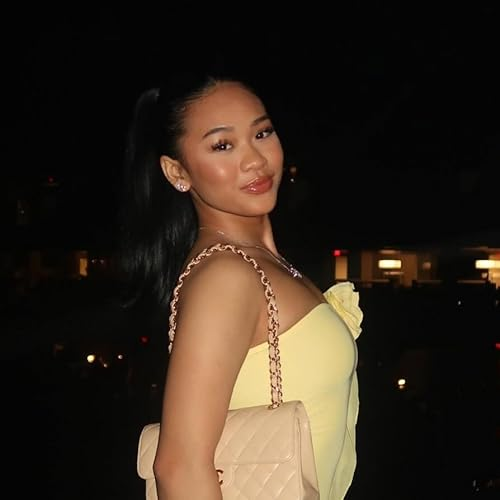 Sunisa Lee in a yellow dress on a rooftop at night