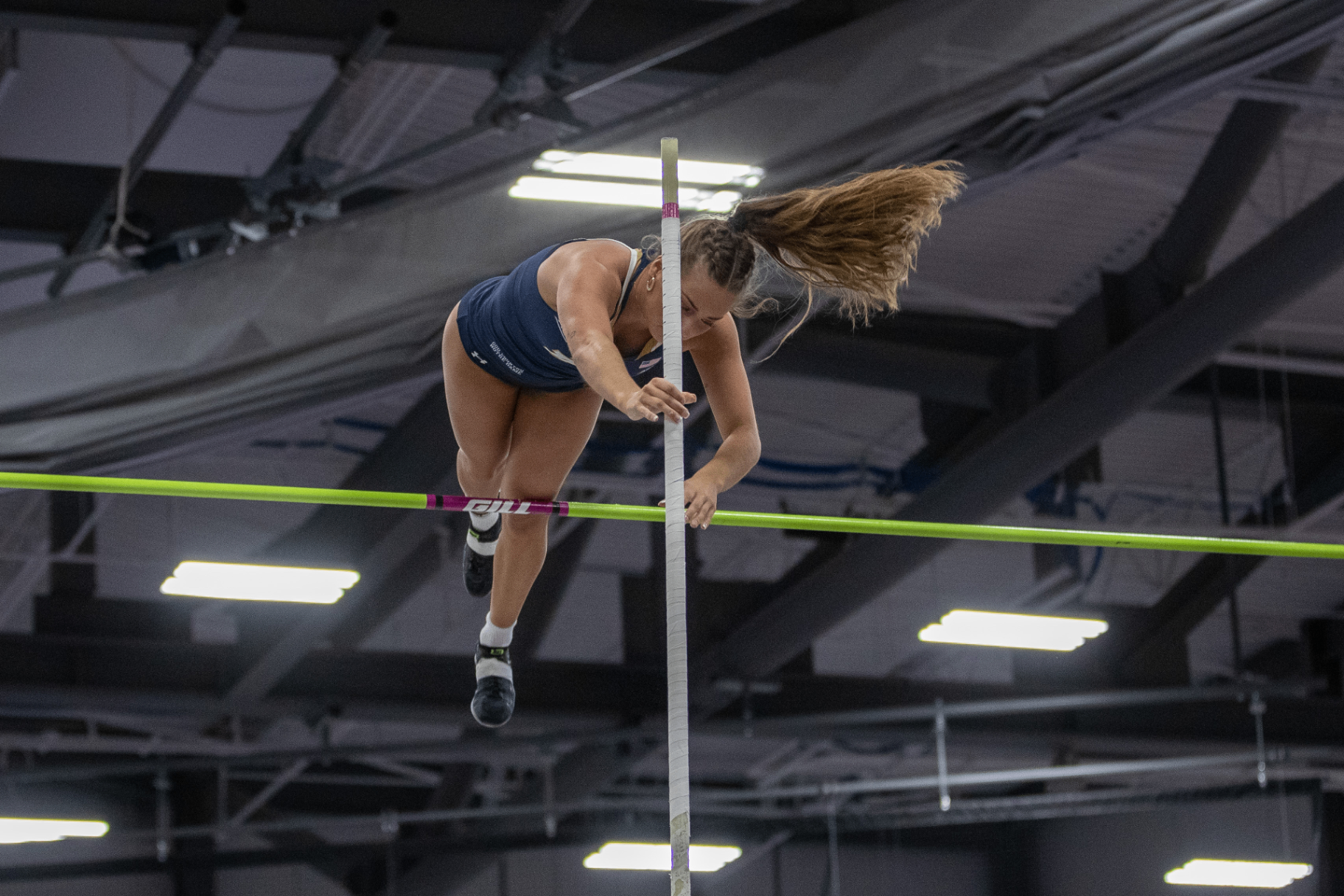 Olivia Fabry clearing the bar mid pole vault for Notre Dame