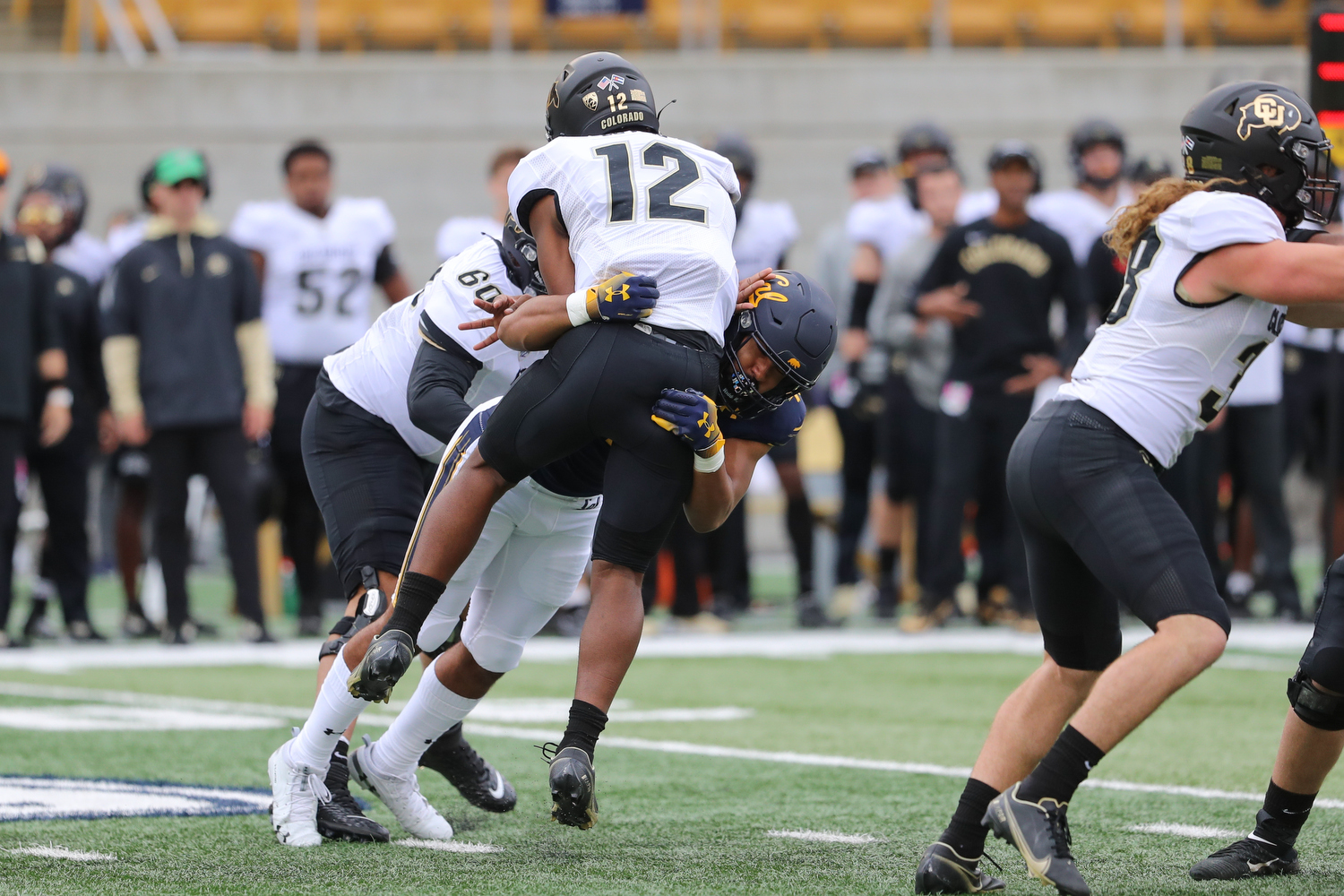 Orin Patu making a tackle for Cal against a Colorado ball carrier