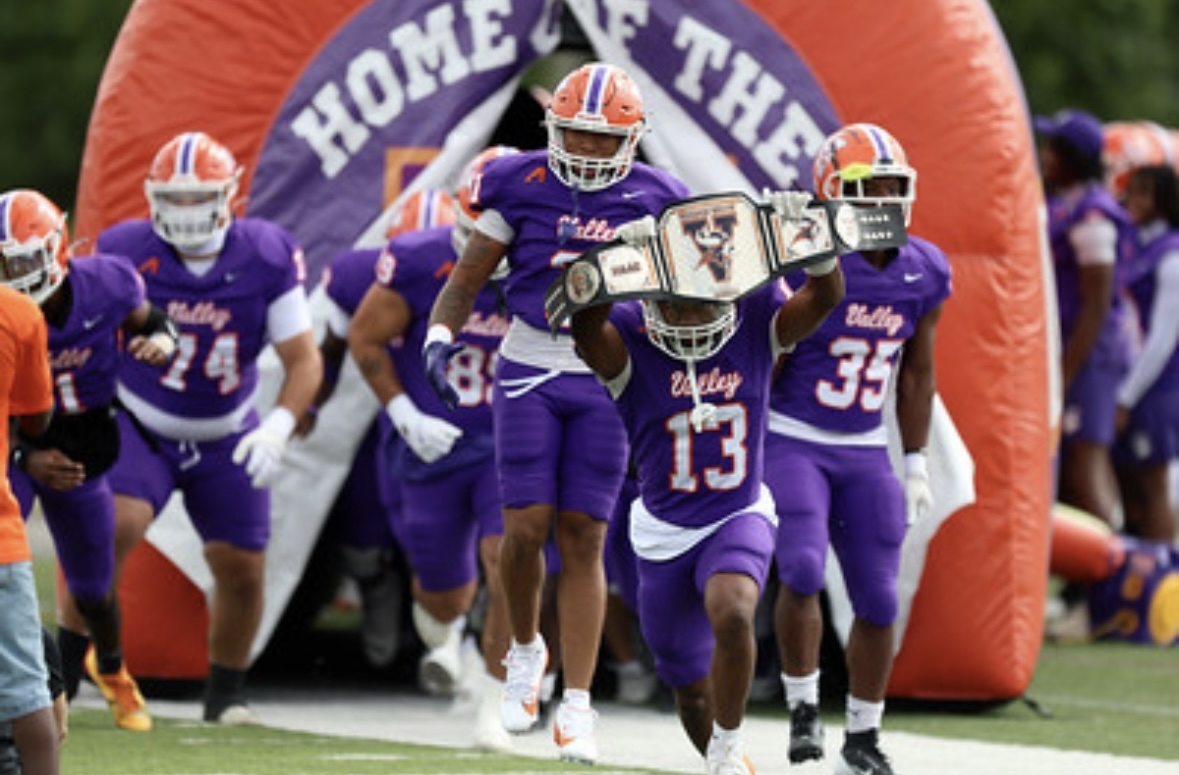 Kylan Wallace entering the field with Missouri Valley teammates before kickoff