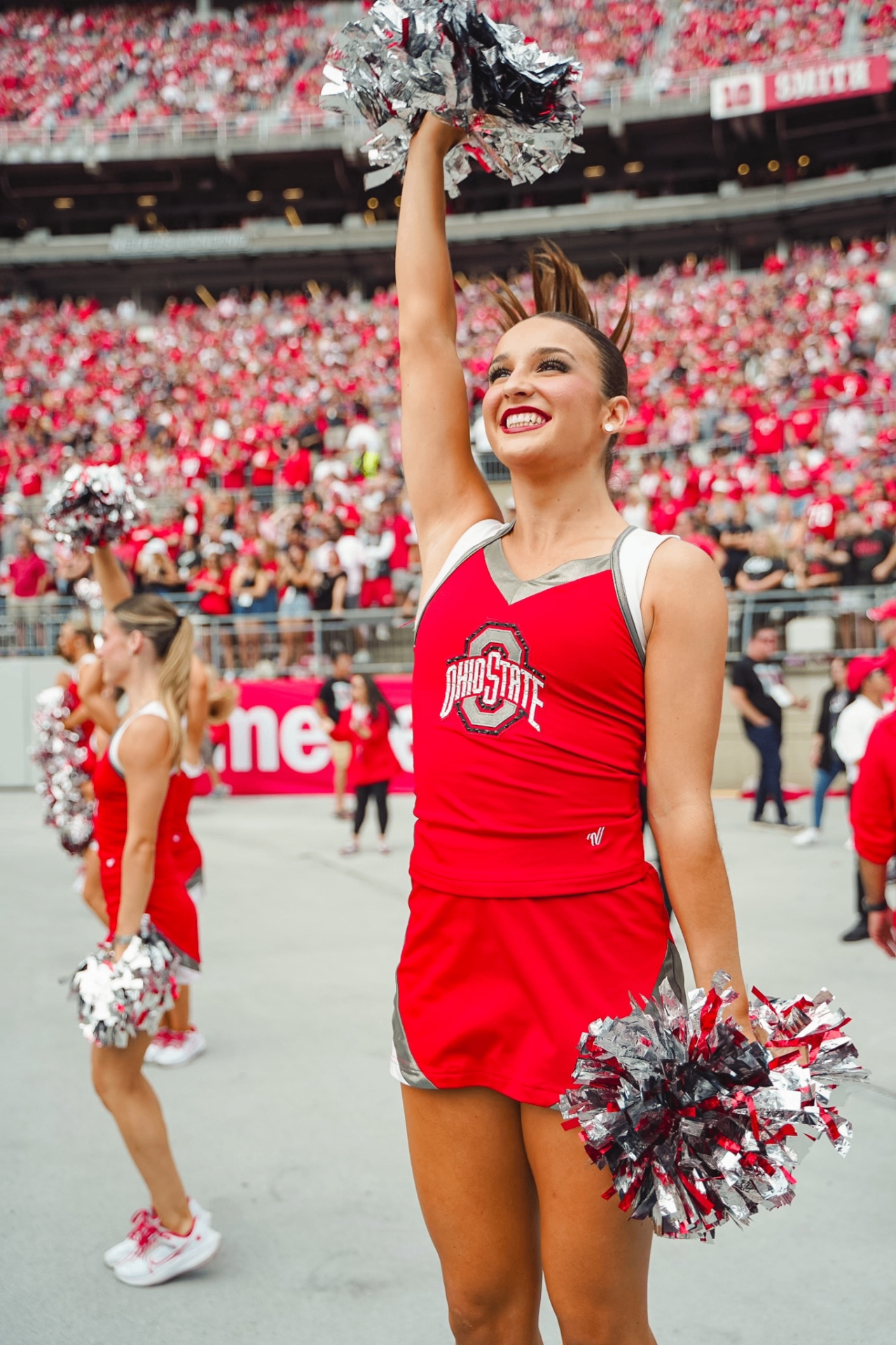 Emma Hellenkamp performing on the field in a red Ohio State dance uniform