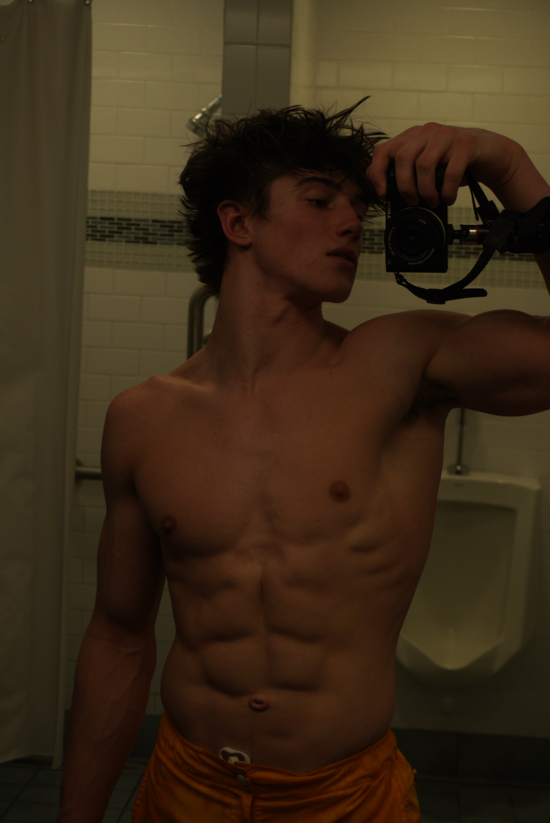 Michael Jaroh holding a camera in a candid mirror shot