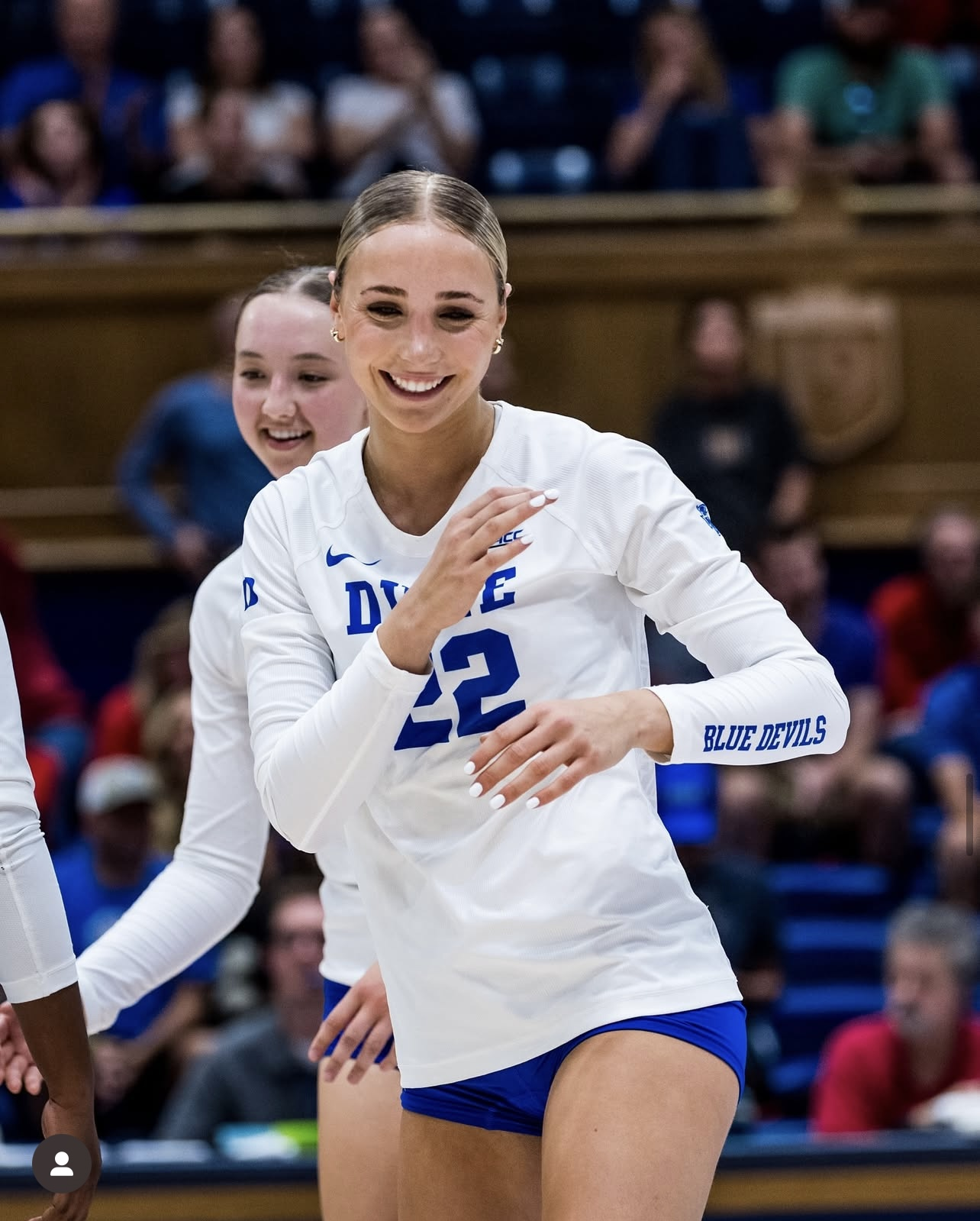 Charlotte Glass playing for Duke in a white uniform