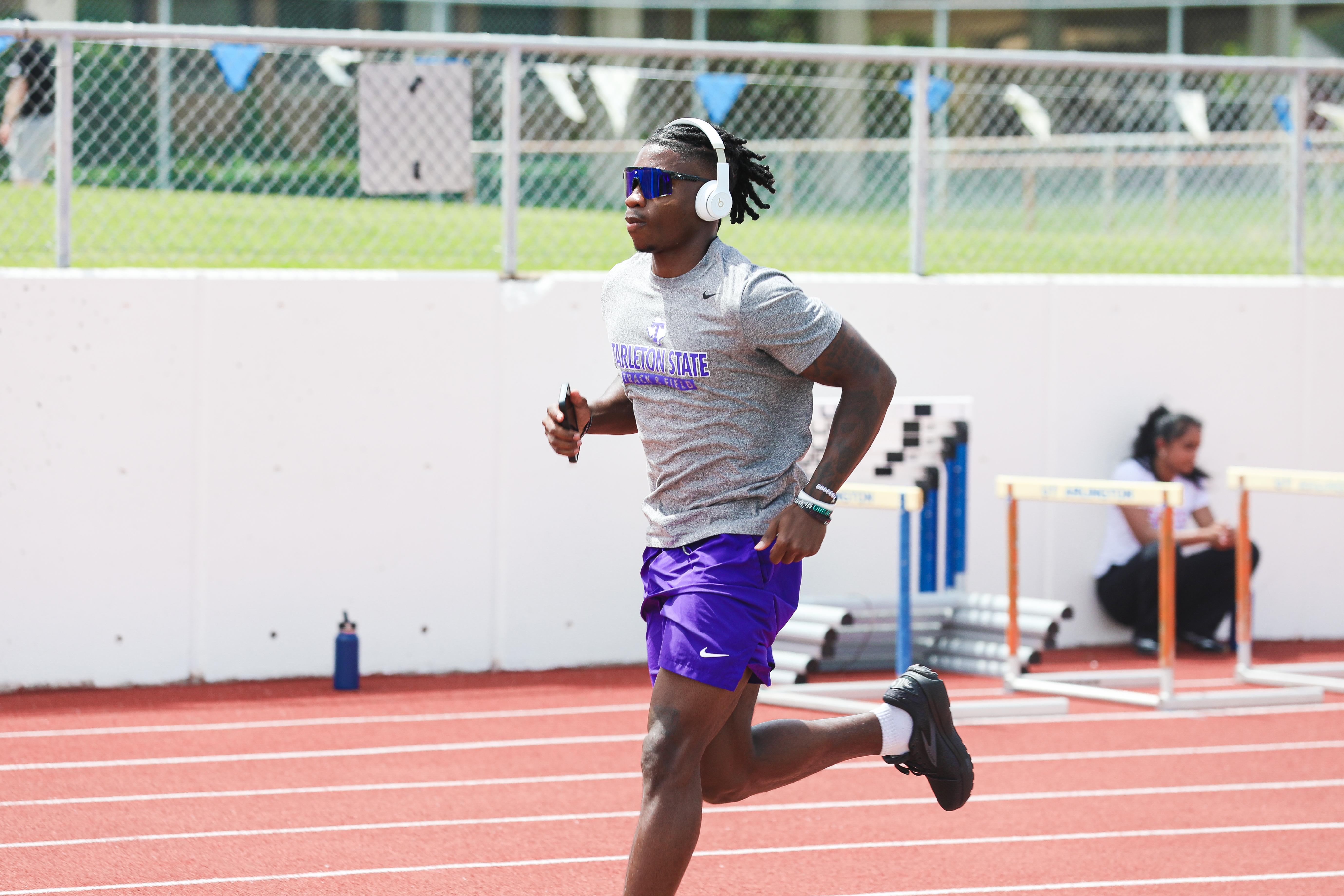 Ca'Terrin Cox running in a gray Tarleton State shirt and purple shorts