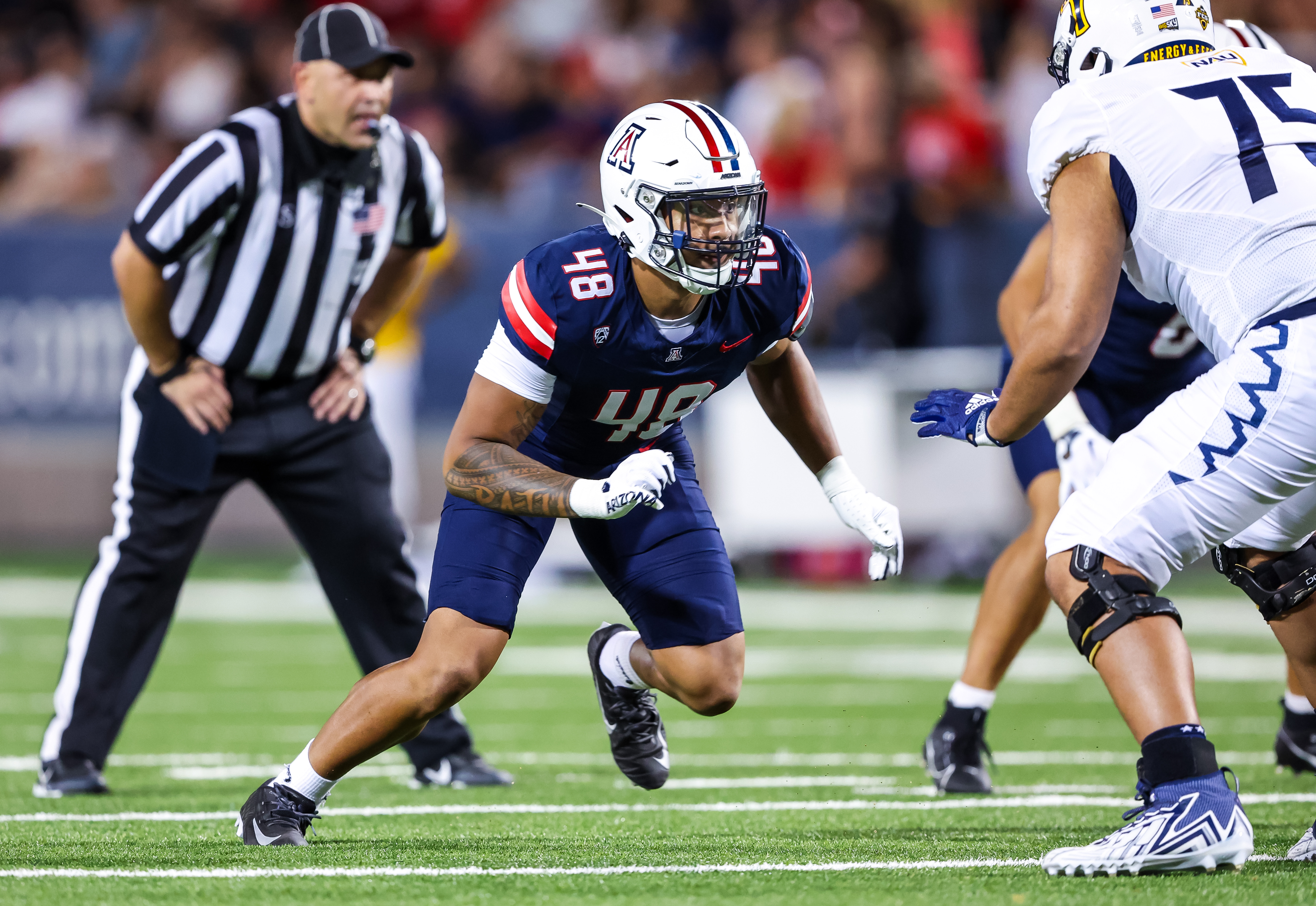 Orin Patu pursuing the play in his Arizona Wildcats home jersey