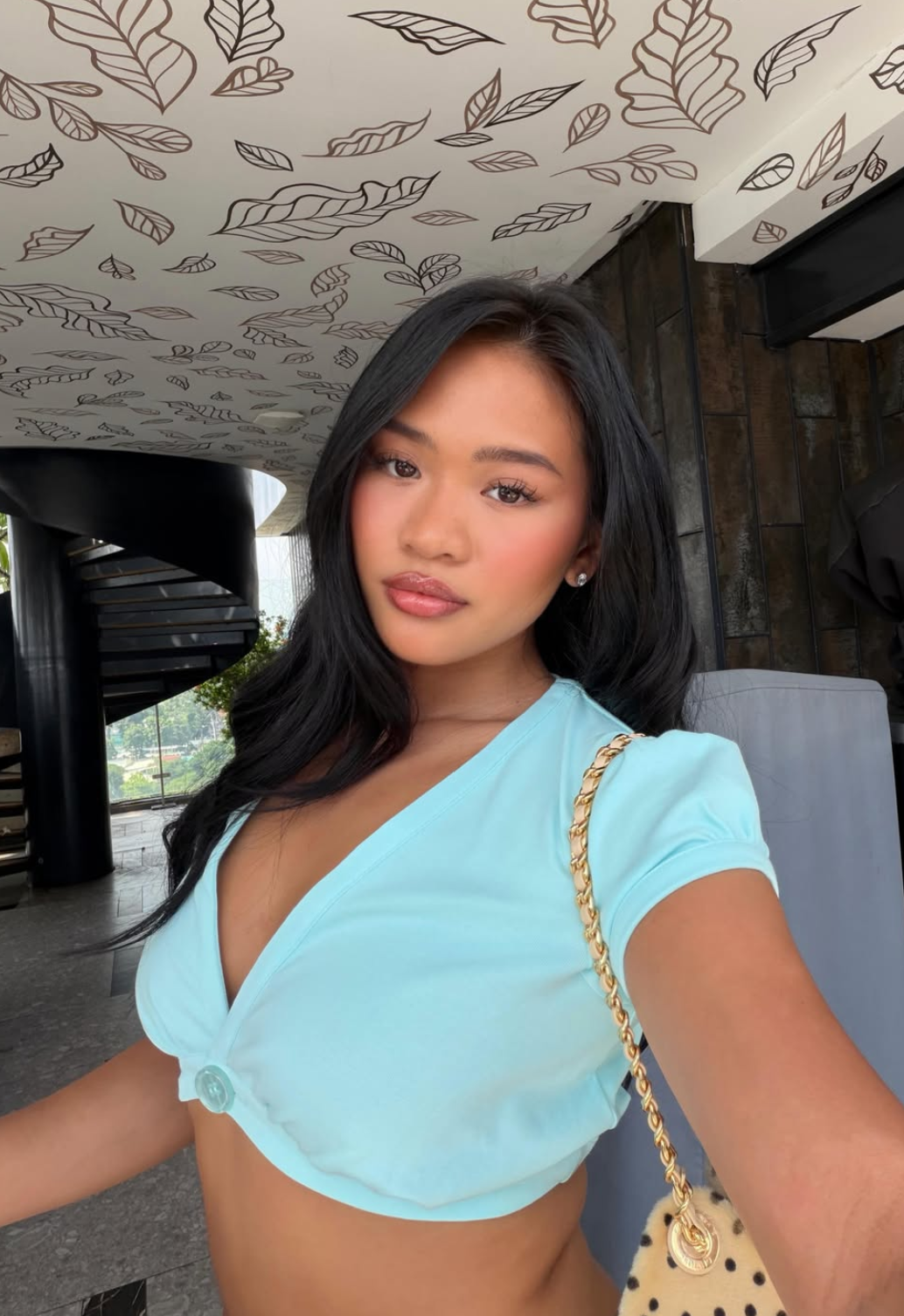 Sunisa Lee in a teal top in a lounge setting