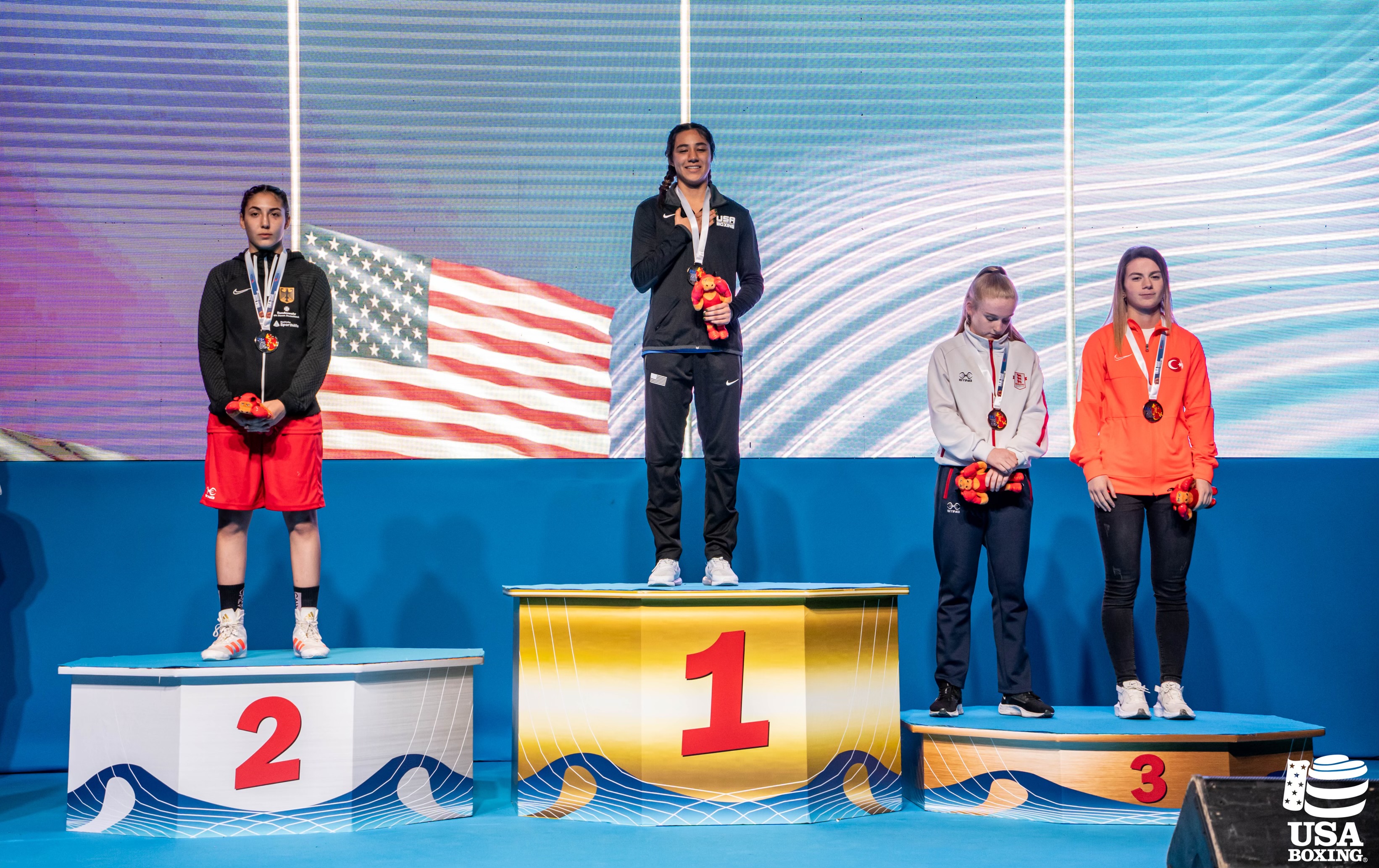Yoseline Perez on the top of the podium with the American flag behind her
