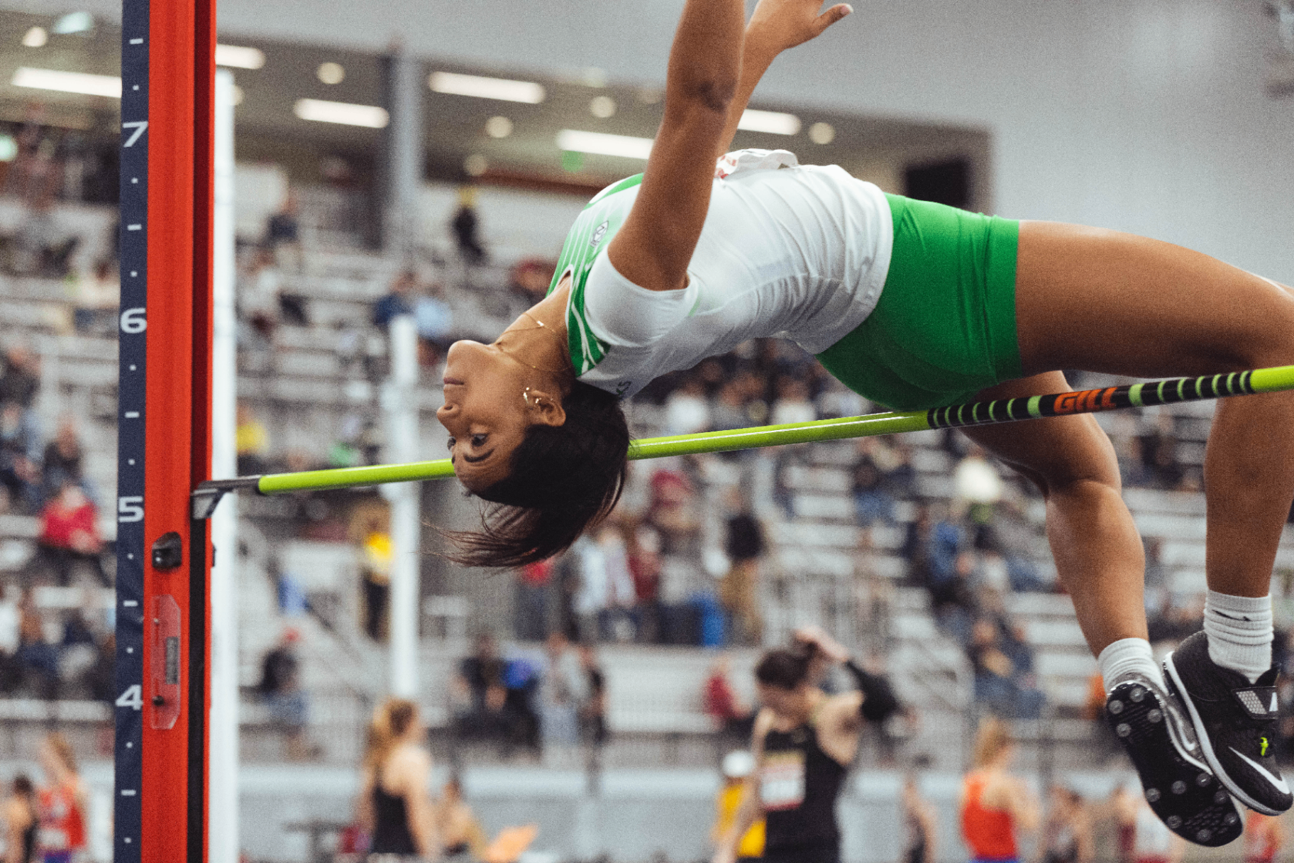 Gianna Bullock clearing the high jump bar
