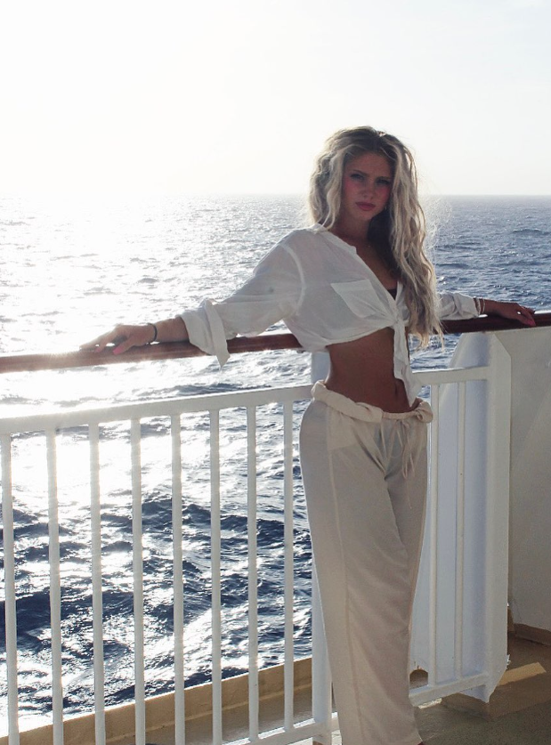Gianna in white by the ocean