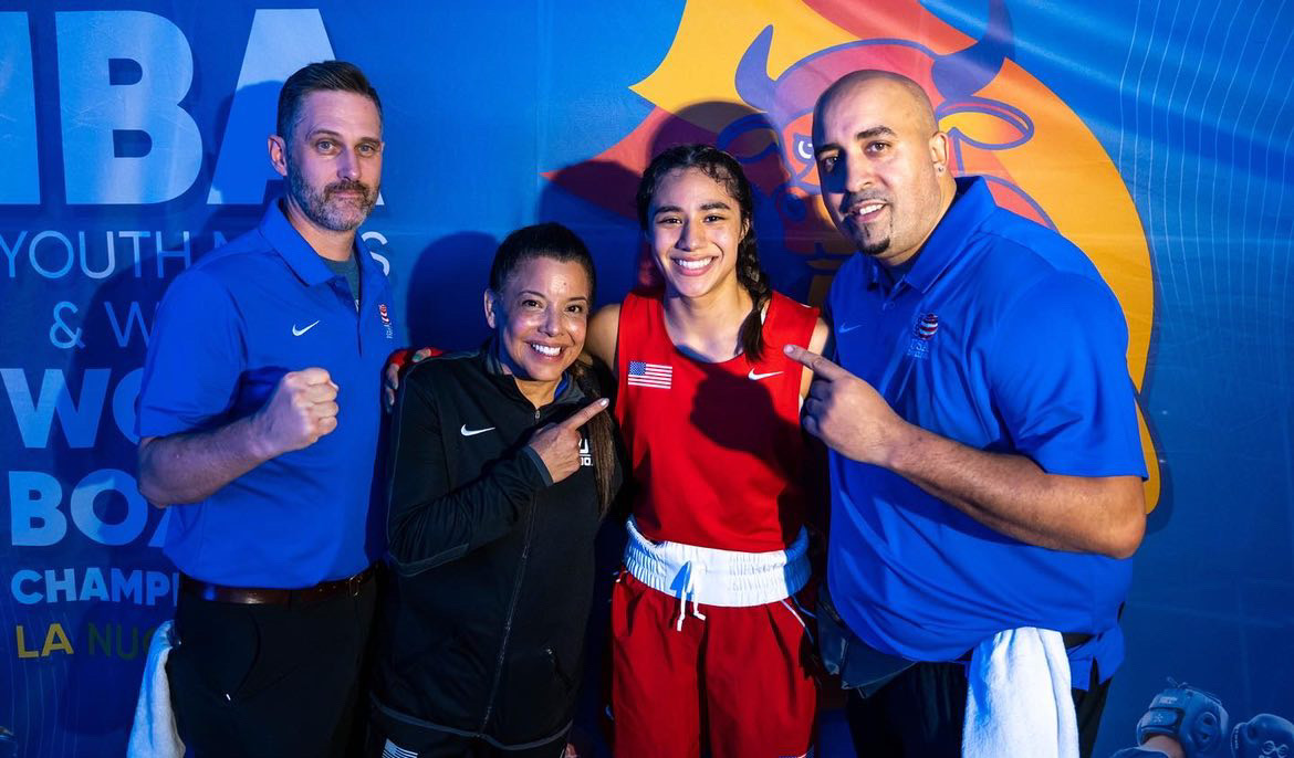 Yoseline Perez celebrating with her Team USA coaches after a bout