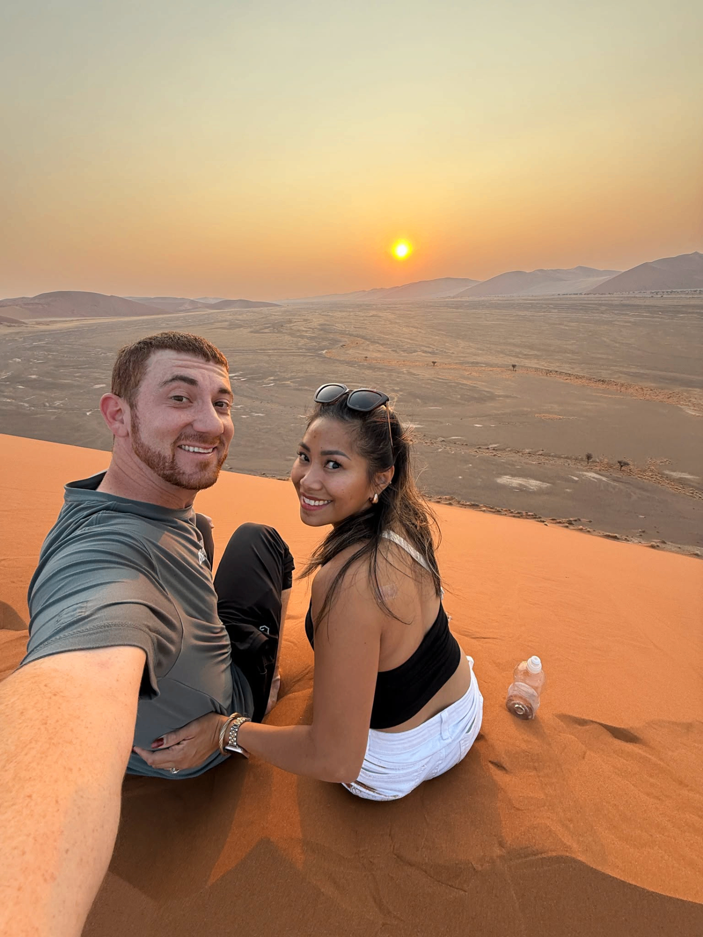Drew Binsky and his partner at sunrise on a Namibian sand dune